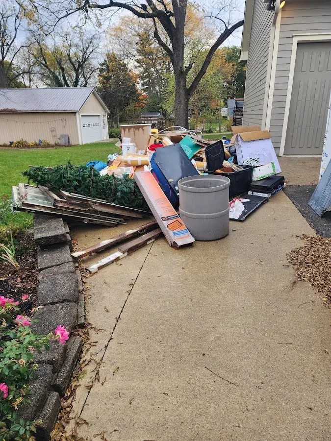 Dumpster being loaded with debris for Estate Cleanout Dumpster Rental in Gladstone